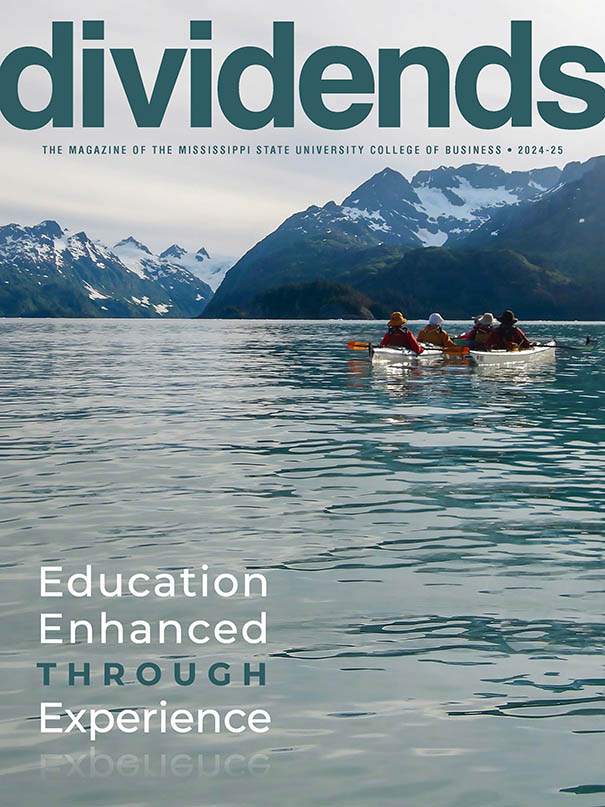 Cover Photo of the 2024-25 edition of Dividends Magazine, showing students kayaking in Alaska while also learning about sustainability and marketing